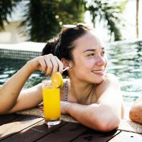a-woman-in-a-pool-with-an-orange-juice.jpg a-woman-in-a-pool-with-an-orange-juice.jpg