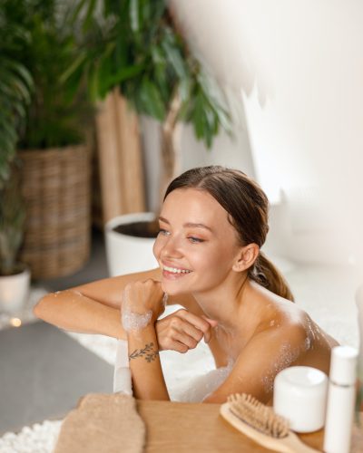 joyful-young-woman-smiling-away-and-leaning-on-bathtub-side-while-bathing-at-spa-resort.jpg joyful-young-woman-smiling-away-and-leaning-on-bathtub-side-while-bathing-at-spa-resort.jpg